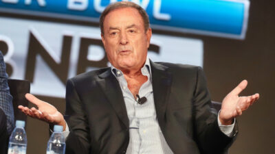 Al Michaels with his arms open