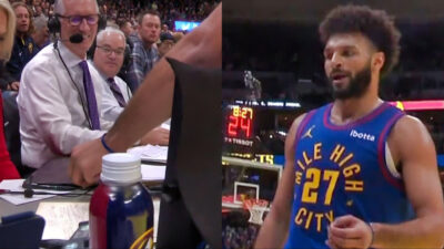 Jamal Murray hands a fly to Doris Burke during the game