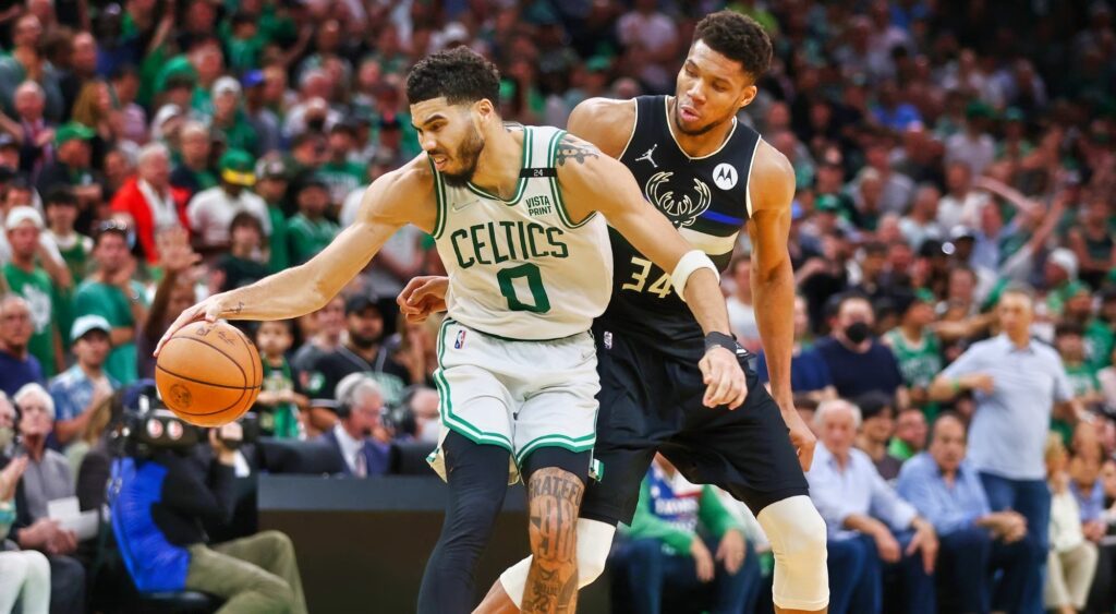 Jayson Tatum of the Boston Celtics handles the ball against Giannis Antetokounmpo of the Milwaukee Bucks