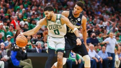 Jayson Tatum of the Boston Celtics handles the ball against Giannis Antetokounmpo of the Milwaukee Bucks