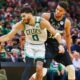 Jayson Tatum of the Boston Celtics handles the ball against Giannis Antetokounmpo of the Milwaukee Bucks