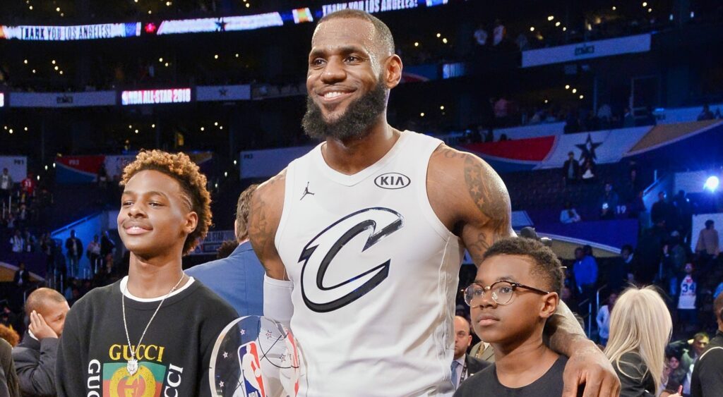 LeBron James Jr., LeBron James and and Bryce Maximus James pose for a photo with the All-Star Game MVP trophy during the NBA All-Star Game 2018