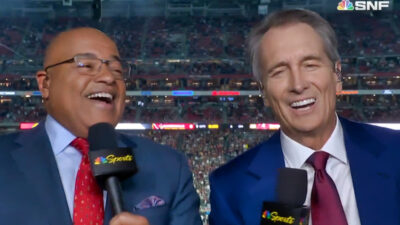 Mike Tirico and Cris Collinsworth laughing