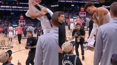 Victor Wembanyama after an NBA match gives his jersey to a young boy