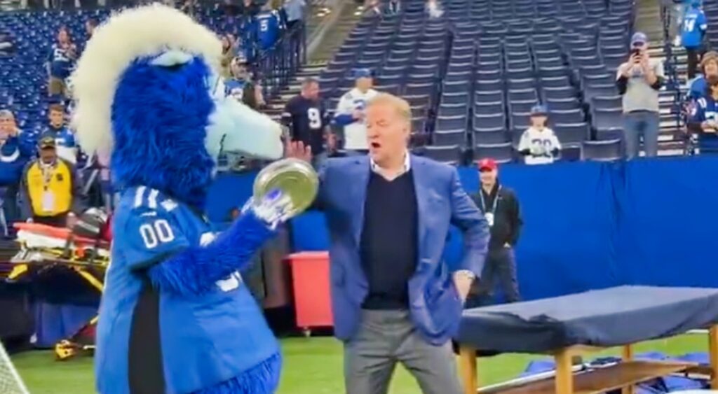 Roger Goodell and colts mascot with a pie