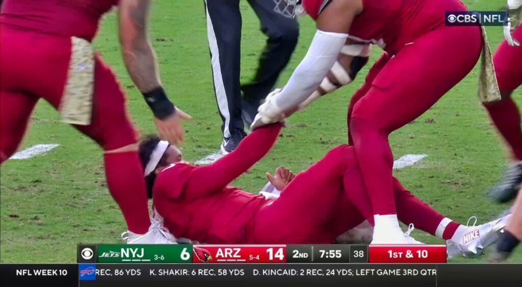 Arizona Cardinals quarterback Kyler Murray getting helped up after hit.