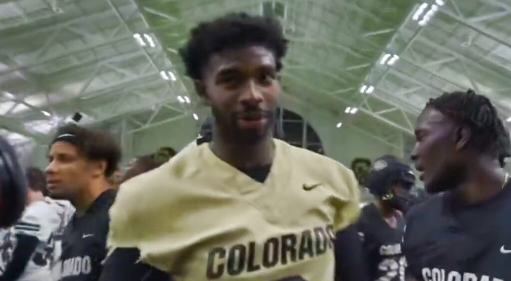 Shedeur Sanders speaking during practice.