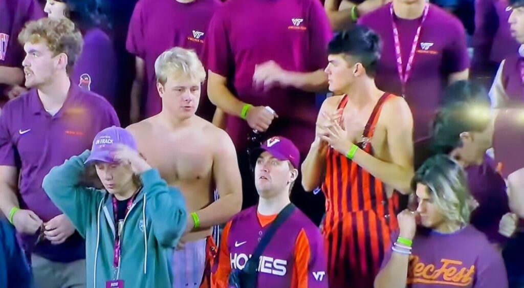 Virginia Tech Hokies fans looking on in stands.