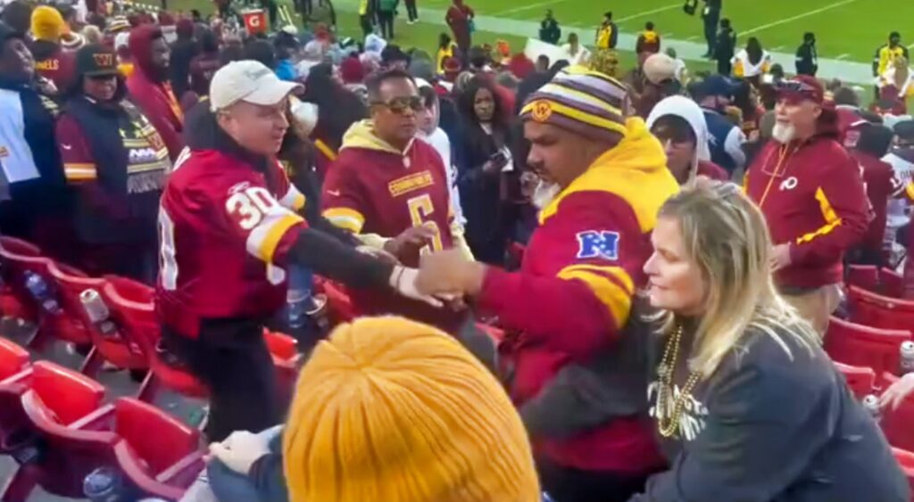 Washington Commanders fans fighting Dallas Cowboys fan.