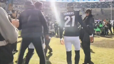 Deion Sanders walking with his sons