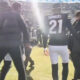 Deion Sanders walking with his sons