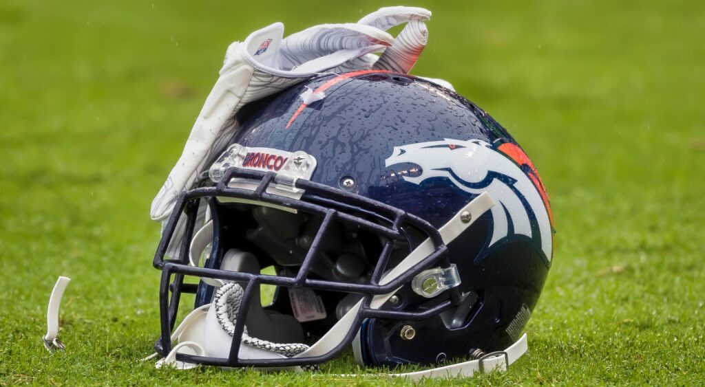 Denver Broncos helmet shown on field.