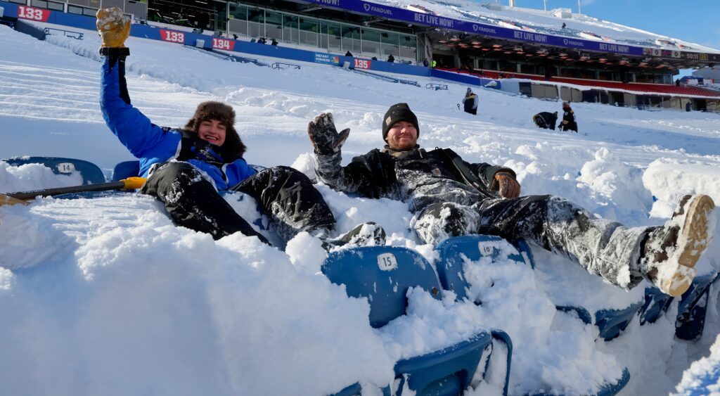 Fans inside Highmark stadium with snow on seats