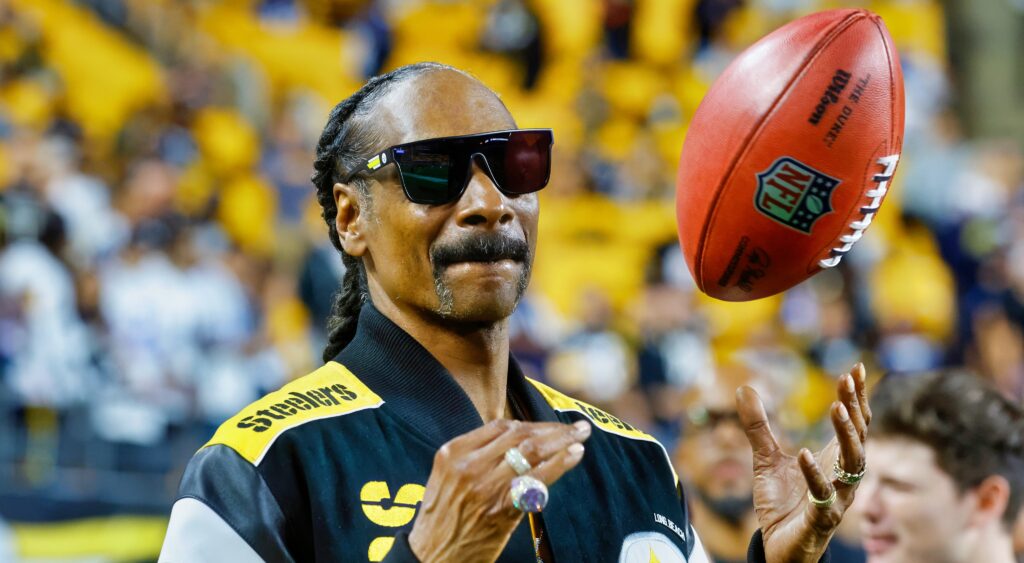 Snoop Dogg in Steelers jacket and throwing football