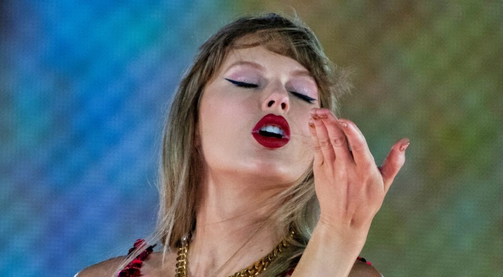 Taylor Swift blows a kiss during her concert.