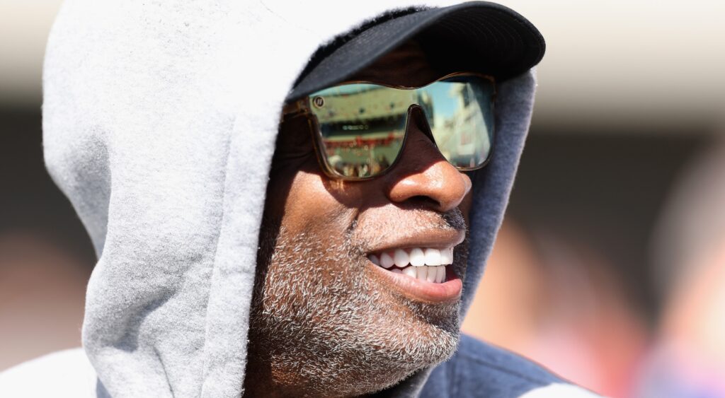 Deion Sanders in hoodie and sunglasses