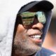 Deion Sanders in hoodie and sunglasses