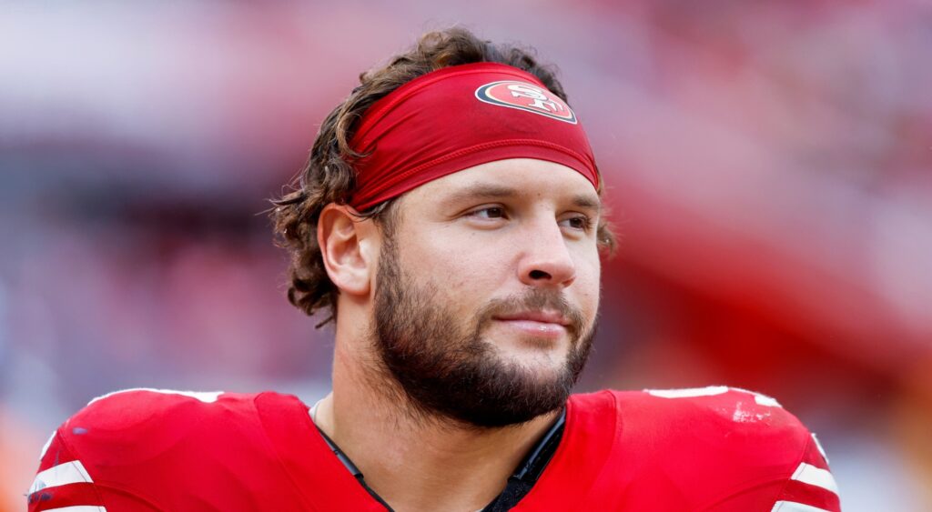 Nick Bosa of San Francisco 49ers looking on.