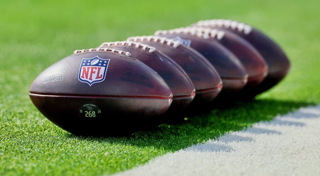 NFL footballs shown on field. The Chicago Bears may reportedly trade for their next coach.