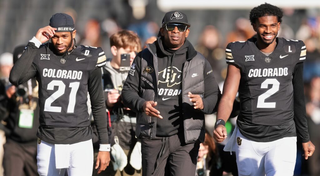 Deion Sanders, Shedeur Sanders, and Shilo Sanders walking on field