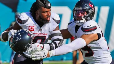 Azeez Al-Shaair in uniform being held back by teammate