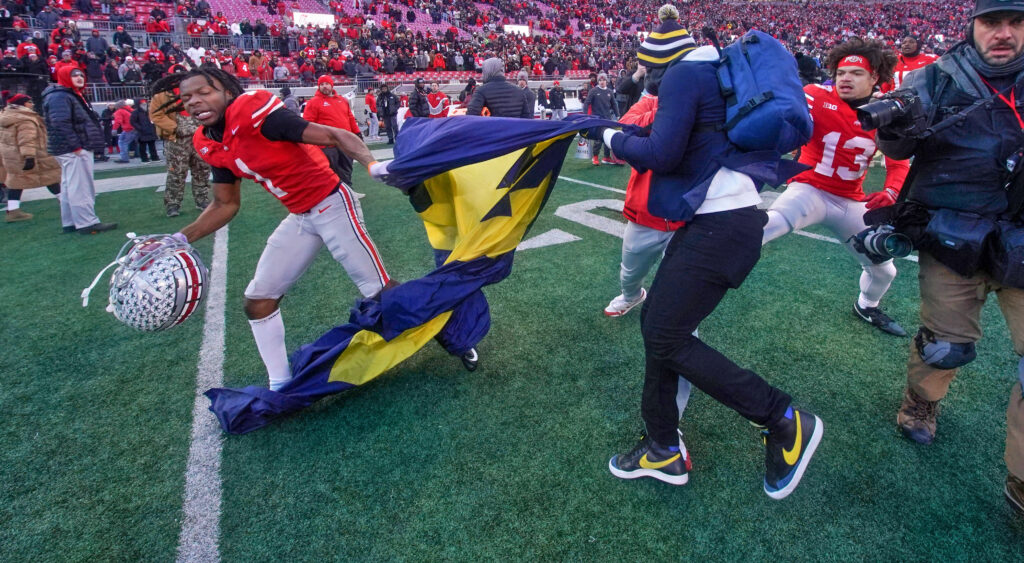 Ohio State player grabbing Michigan flag during postgame brawl