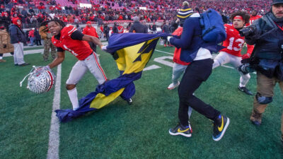 Ohio State player grabbing Michigan flag during postgame brawl