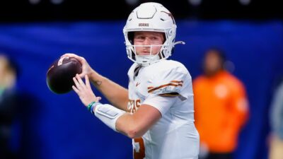 Quinn Ewers throwing football