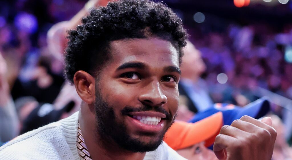 Shedeur Sanders sitting courtside