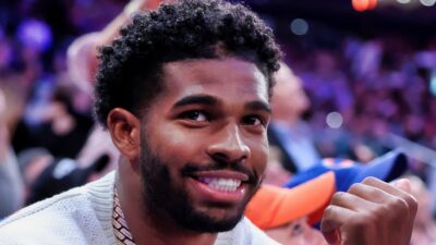 Shedeur Sanders sitting courtside