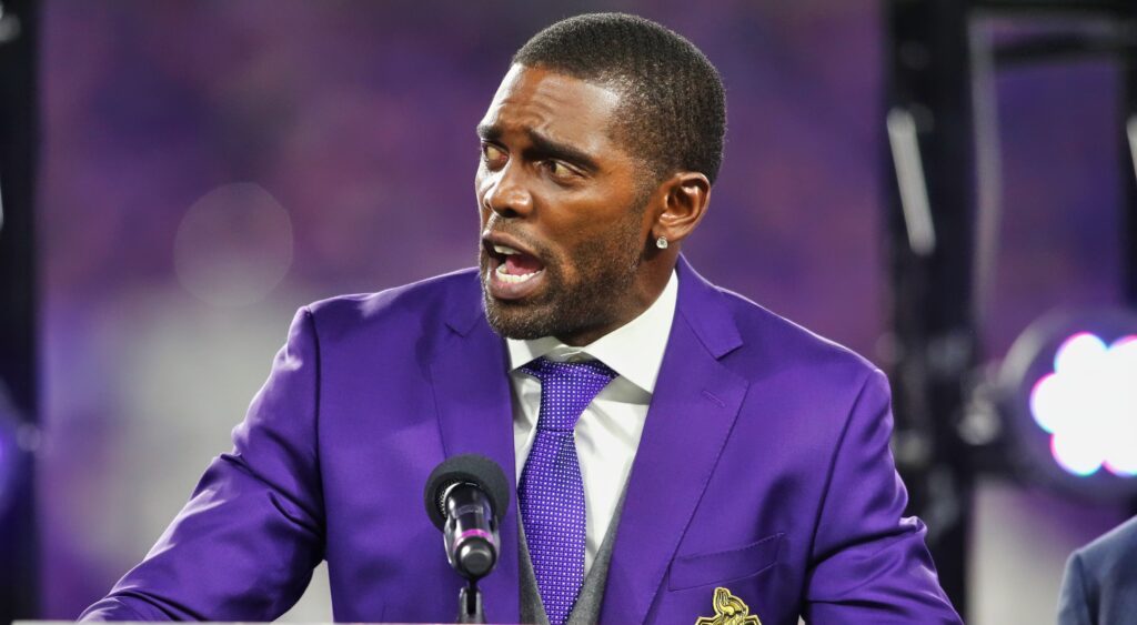 Randy Moss in purple suit