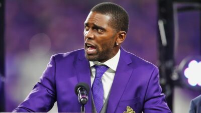 Randy Moss in purple suit