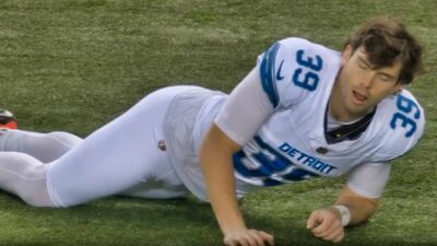 Jake Bates stretching on field