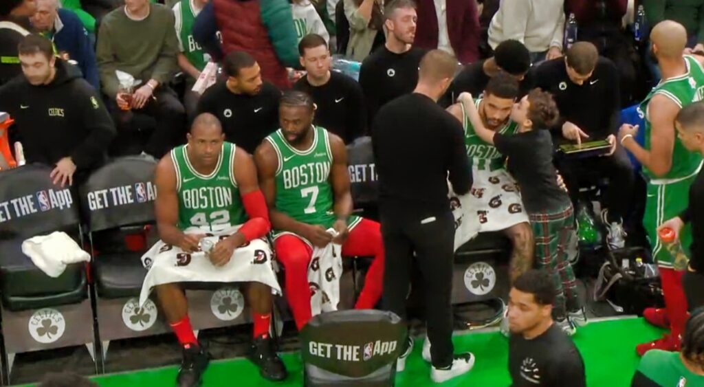 Jayson Tatum's son Deuce giving him a kiss on check during a time out