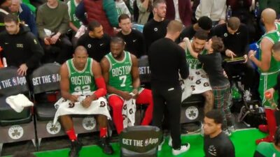 Jayson Tatum's son Deuce giving him a kiss on check during a time out