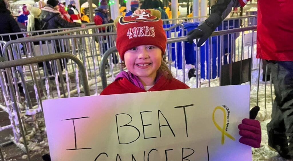 Mia DeCamilla at Buffalo Bills game with sign