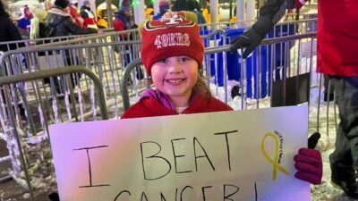 Mia DeCamilla at Buffalo Bills game with sign