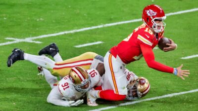 Quarterback Patrick Mahomes of the Kansas City Chiefs is tackled after a 3-yard run by defensive end Arik Armstead and defensive tackle Javon Hargrave of the San Francisco 49ers