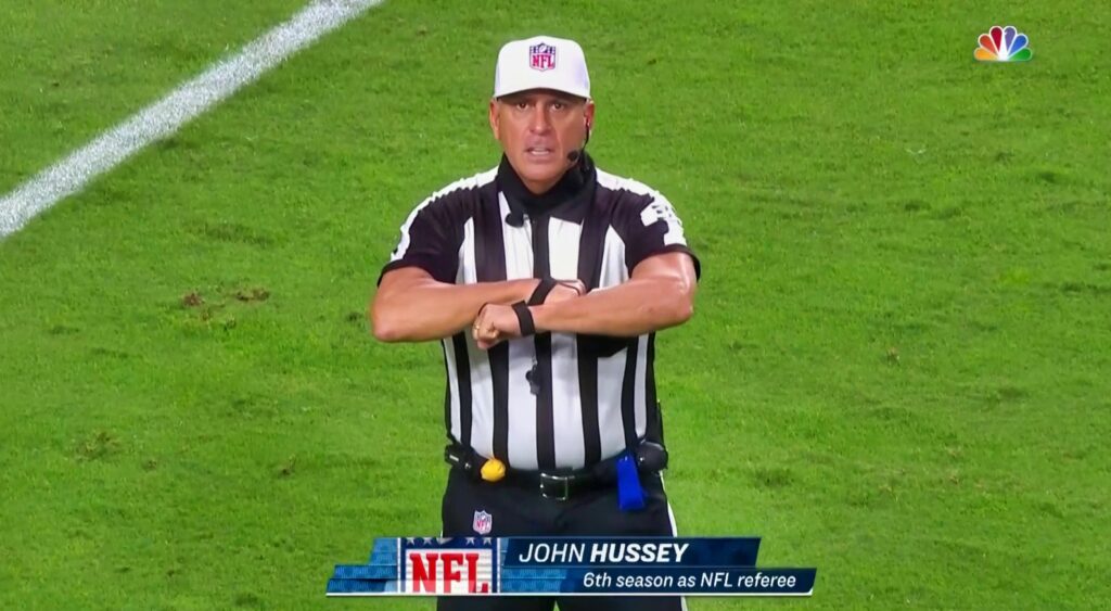 NFL referee John Hussey signals for a false start.