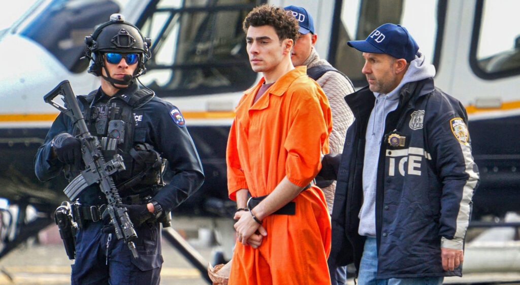 PHOTOS: Social Media Detectives Noticed Police Officer Escorting Luigi Mangione During His Extradition To New York Was Wearing Rare Pair Of Jordans