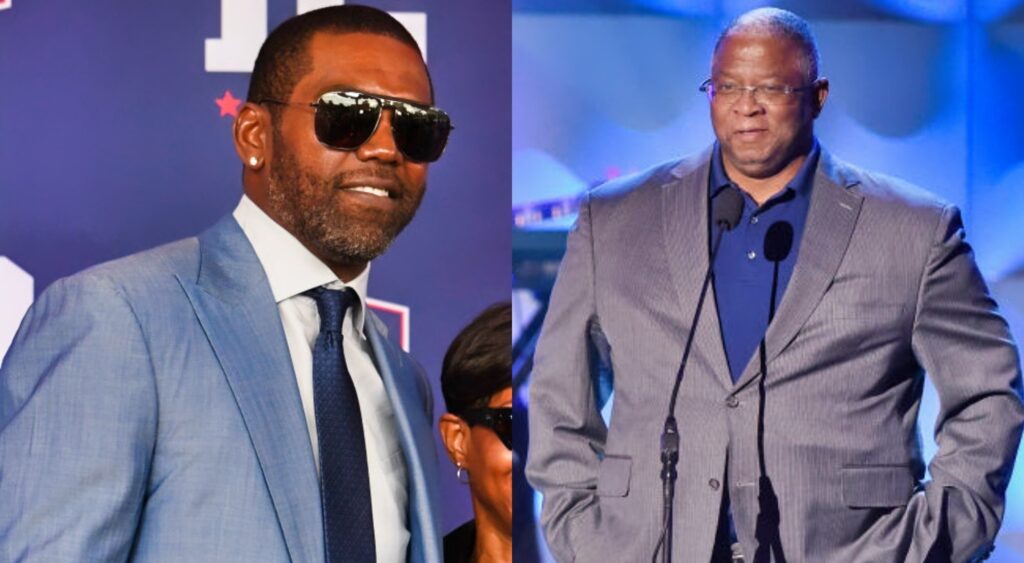 Randy Moss posing in suit and Larry Fitzgerald Sr on stage