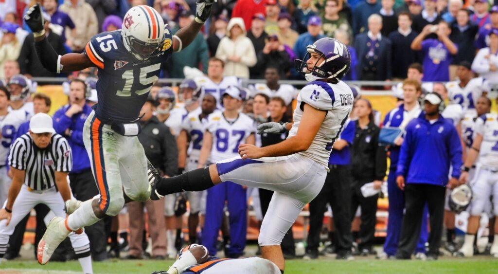 Kicker Stefan Demos of the Northwestern Wildcats follows through on a field goal attempt against the Auburn Tigers and was called for roughing the kicker.