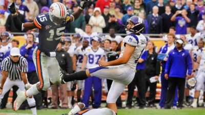 Kicker Stefan Demos of the Northwestern Wildcats follows through on a field goal attempt against the Auburn Tigers and was called for roughing the kicker.