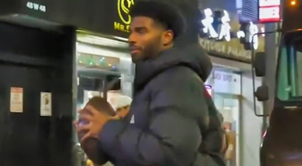 Shedeur Sanders holding football