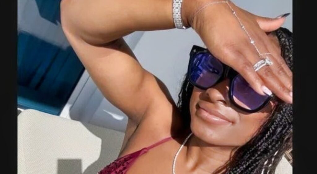 Simone Biles in a bikini and covering her eyes