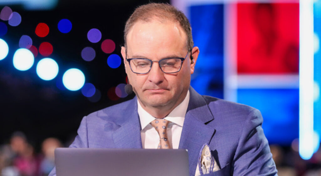 Adrian Wojnarowski looking at laptop