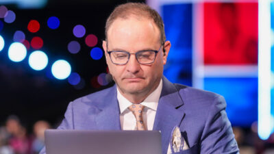 Adrian Wojnarowski looking at laptop