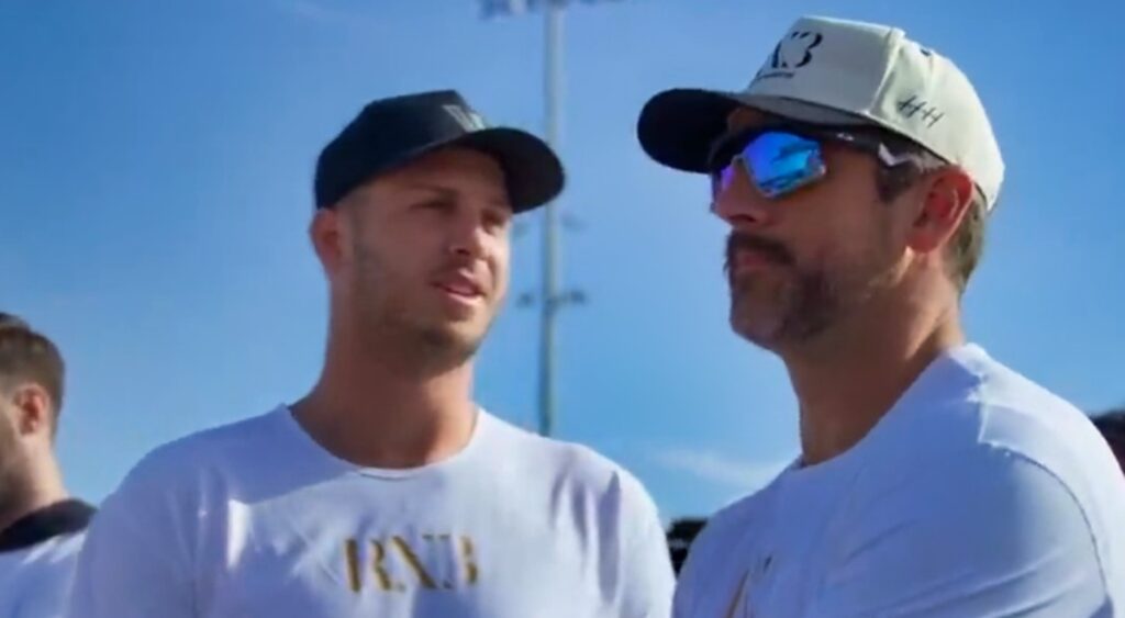 Jared Goff and Aaron Rodgers speaking at an event.