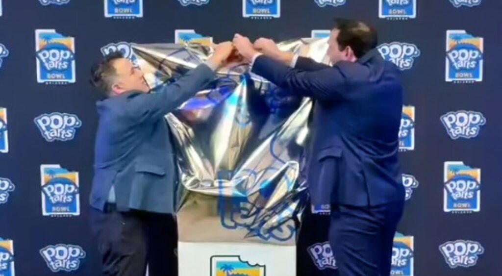 The 2024 Pop-Tarts Bowl trophy being revealed.