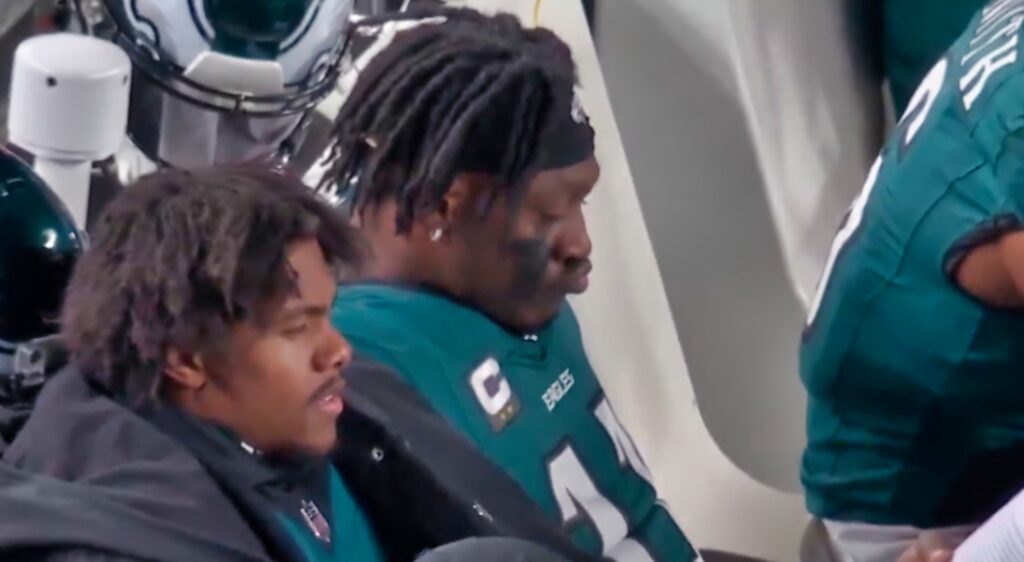 AJ Brown reading on the Eagles bench